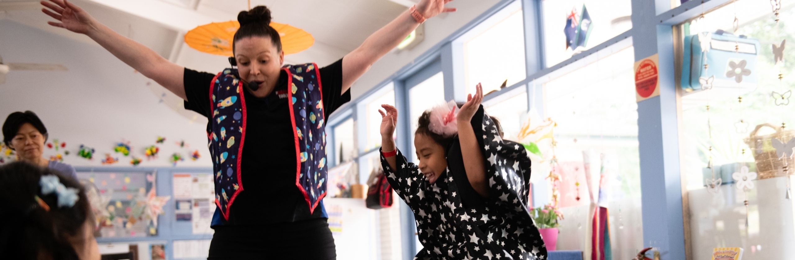 picture of teacher and child jumping